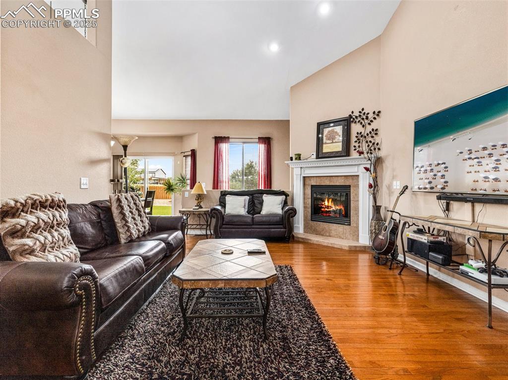 Image 2 of 46: Living room featuring a high ceiling, light wood-style flooring, a tile fir
