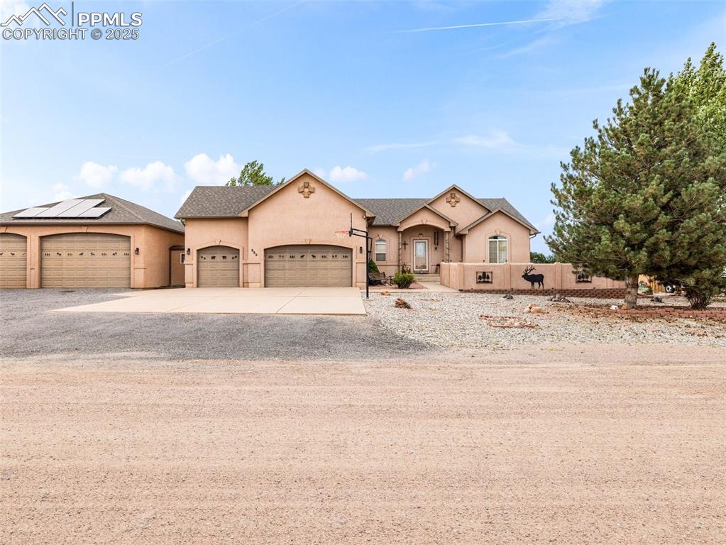 Image 44 of 46: View of front facade with concrete driveway, stucco siding, an attached gar