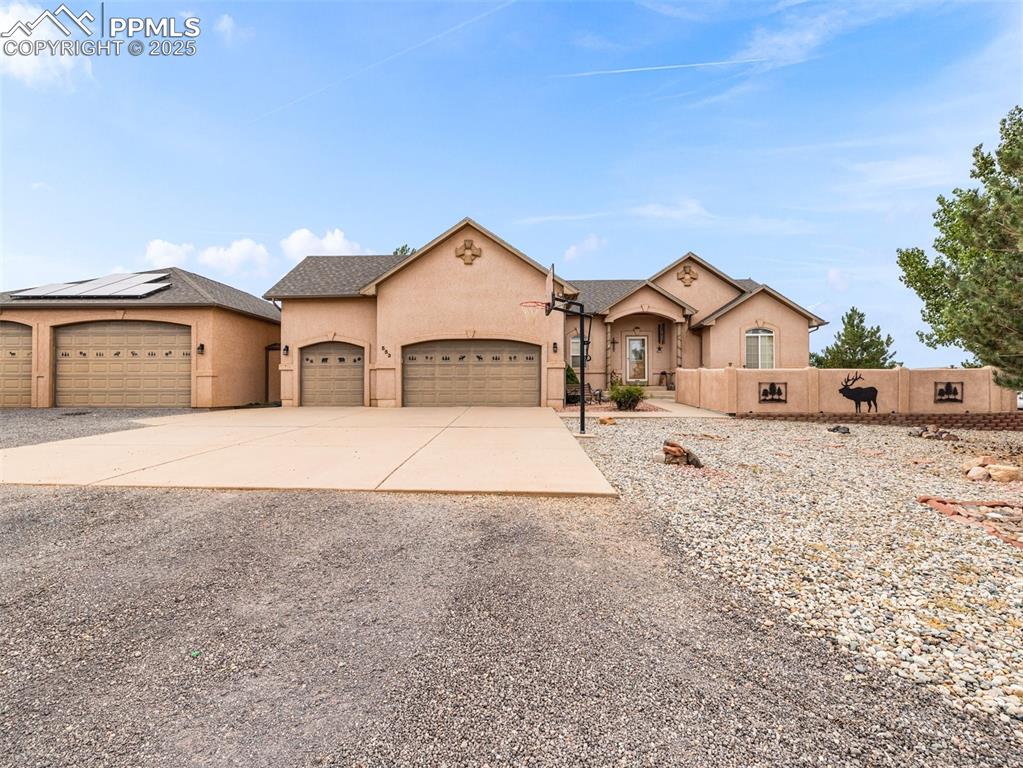Image 45 of 46: View of front of house featuring concrete driveway, stucco siding, and a ga
