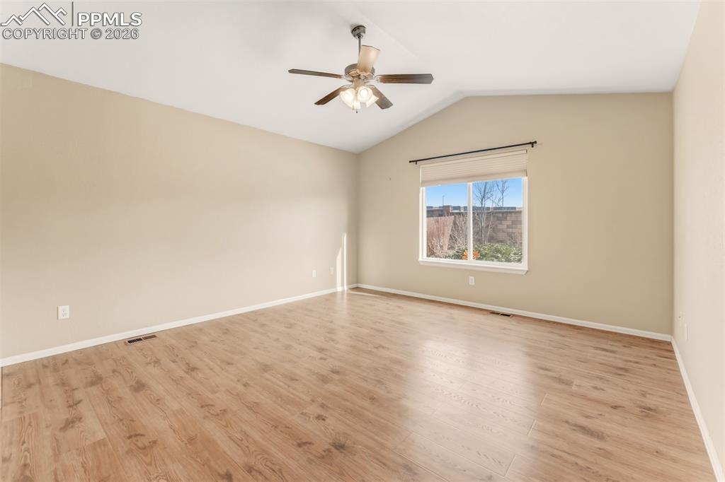 Image 12 of 35: Primary bedroom with ceiling fan and LPV flooring.