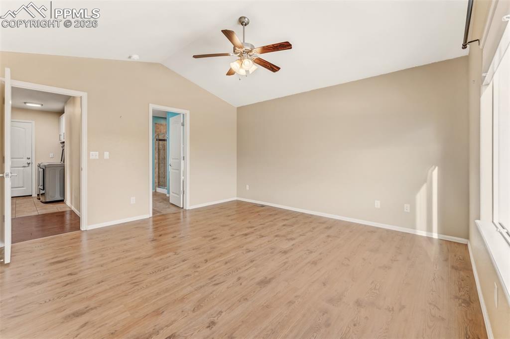 Image 14 of 35: Primary suite looking towards hallway and private bathroom.