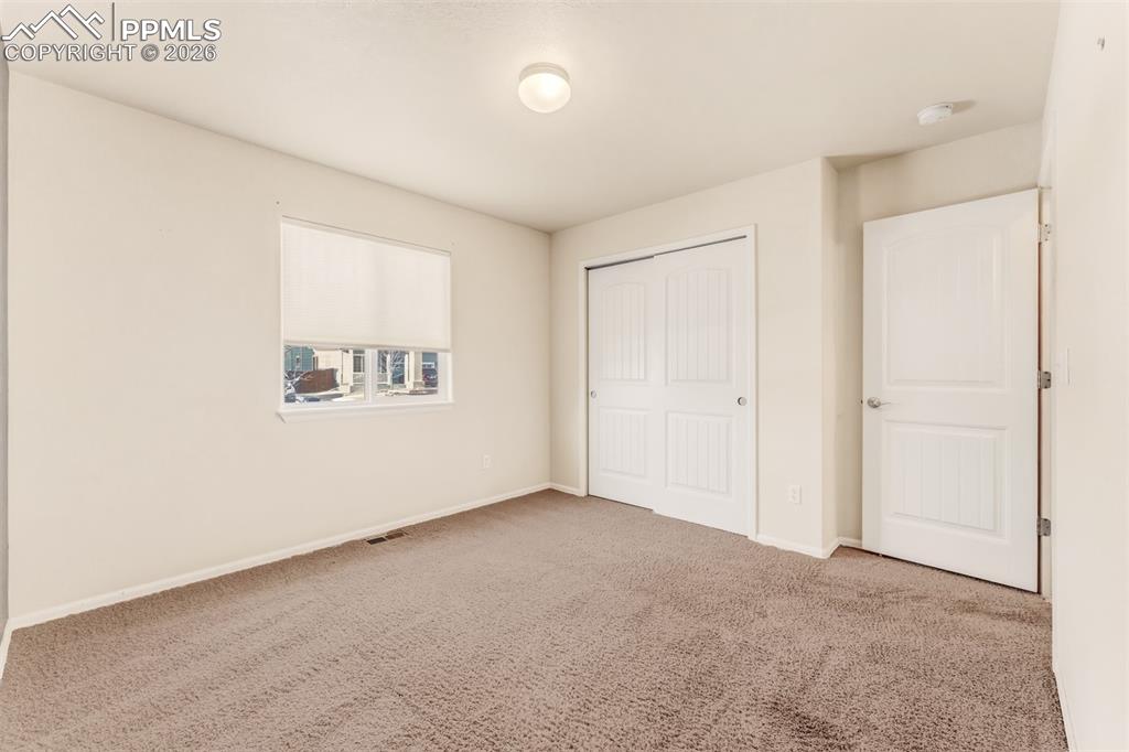 Image 17 of 35: Second bedroom on the main level.