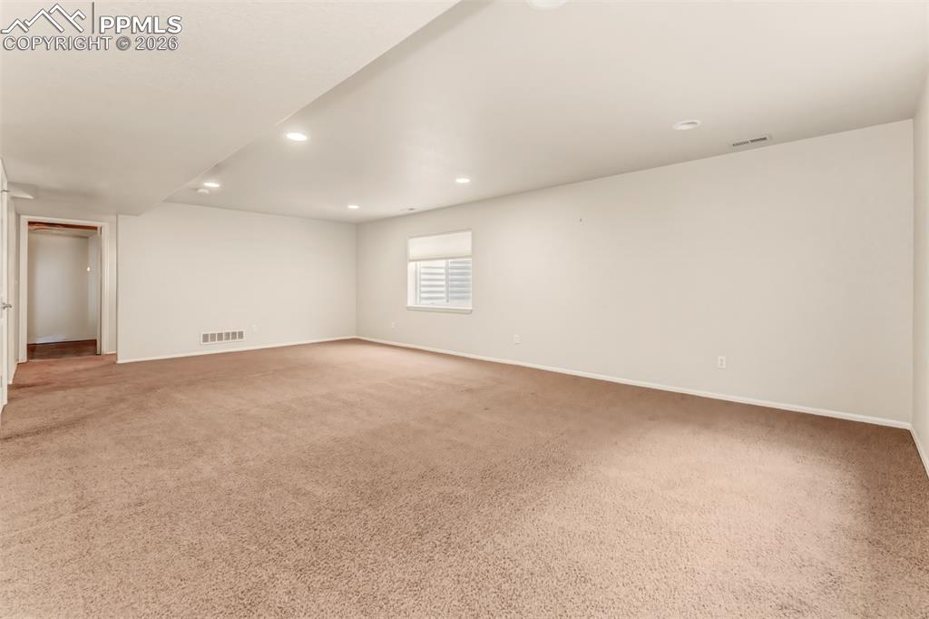 Image 23 of 35: Large entertainment space in the basement.