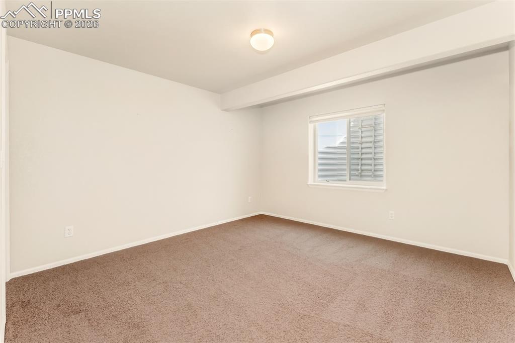 Image 27 of 35: Bedroom #3 located in the basement near the storage room.