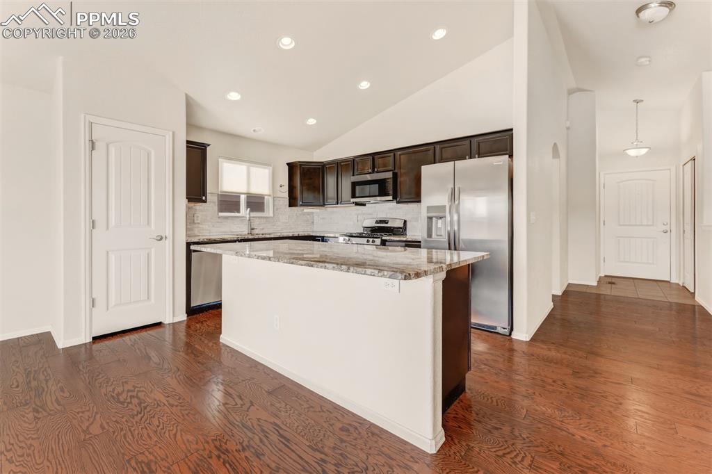 Image 8 of 35: Kitchen with granite countertops, large center island, stainless steel appl