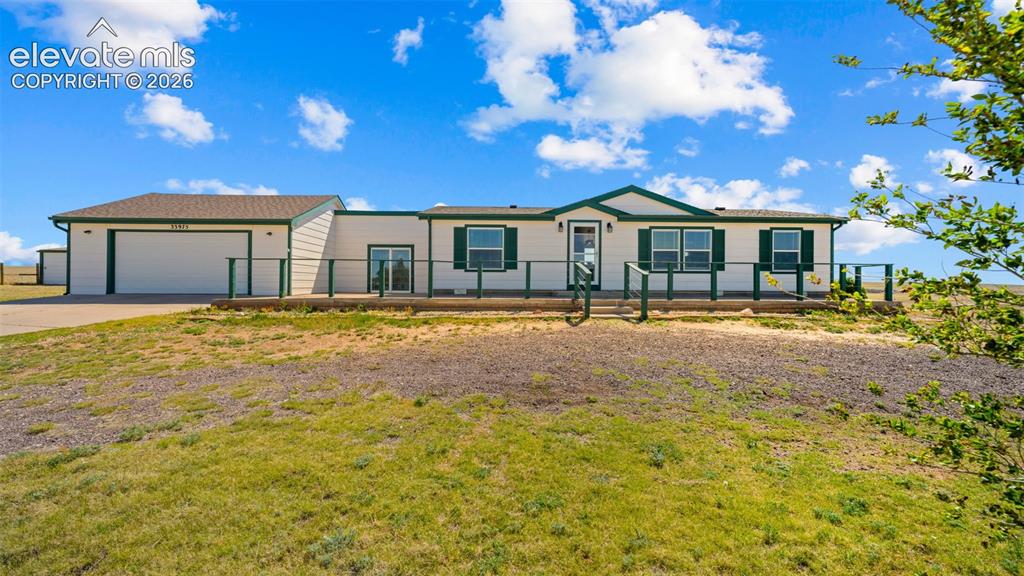Image 2 of 40: Ranch-style residence featuring a prominent attached two-car garage