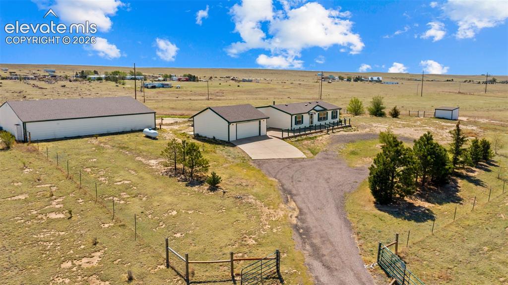 Image 28 of 40: Expansive property featuring a residence, detached garage, and large auxili