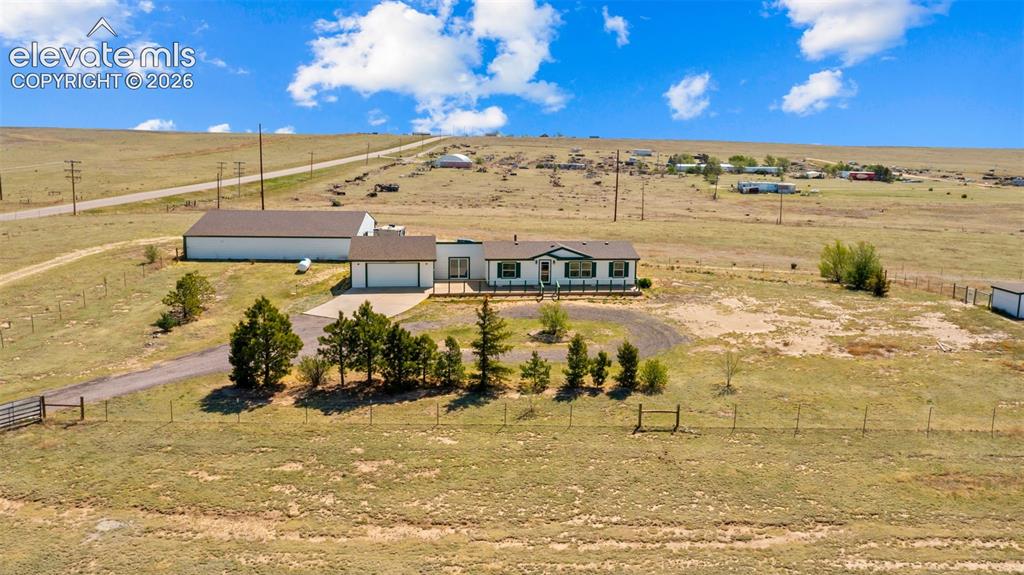 Image 29 of 40: Expansive property featuring a single-story residence with a two-car garage