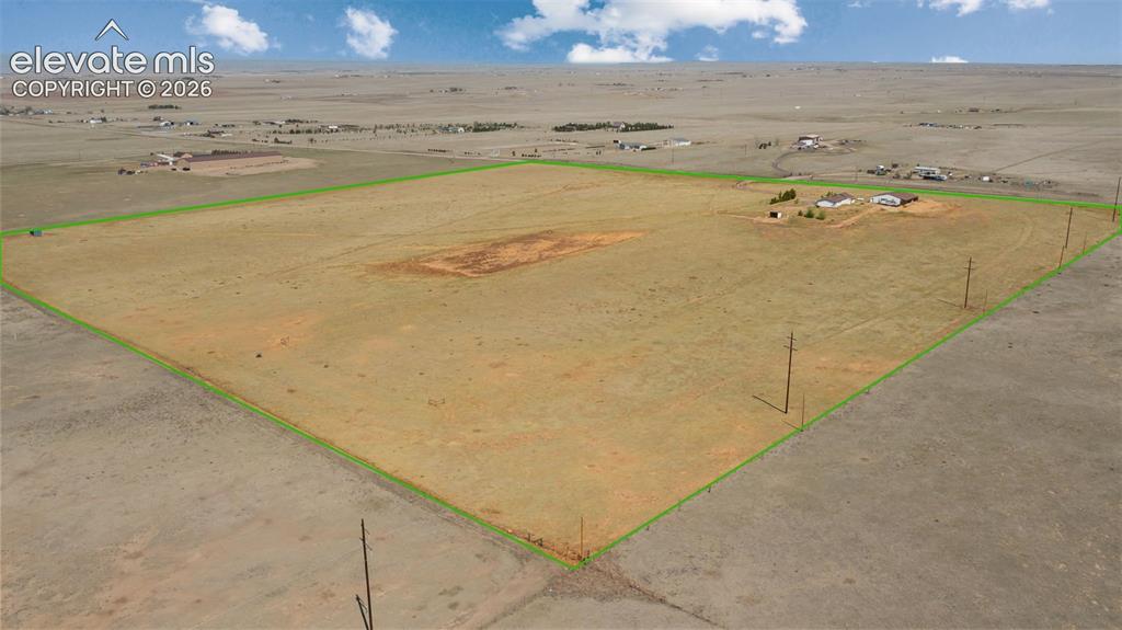 Image 36 of 42: Expansive acreage featuring a perimeter outline, scattered utility poles, a