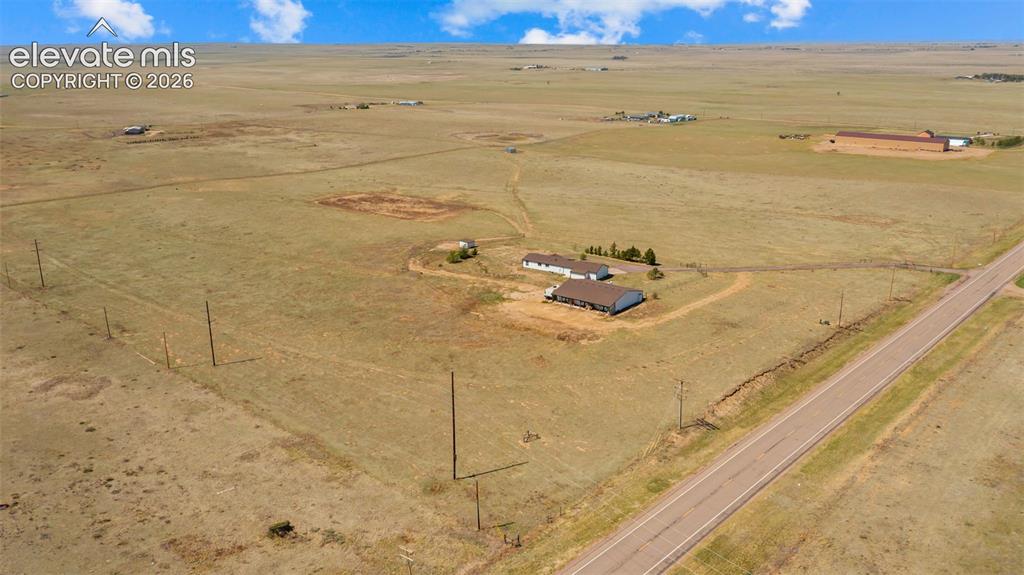 Image 36 of 40: Expansive rural property featuring a main residence, an additional structur