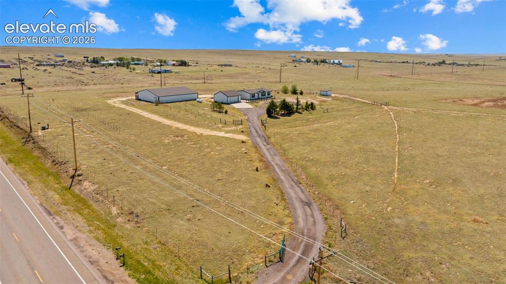 Image 37 of 40: Expansive rural property featuring a primary residence, a large outbuilding