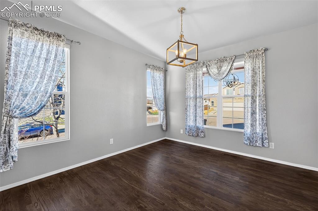 Image 23 of 50: Unfurnished dining area with wood finished floors, healthy amount of natura