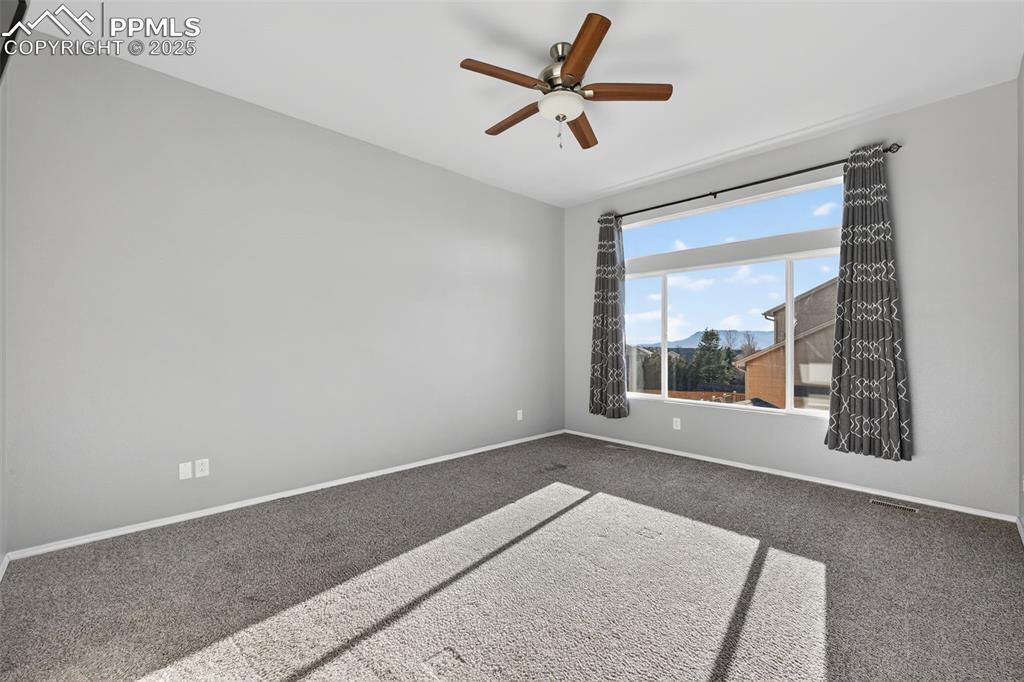 Image 28 of 50: Empty room featuring carpet and a ceiling fan