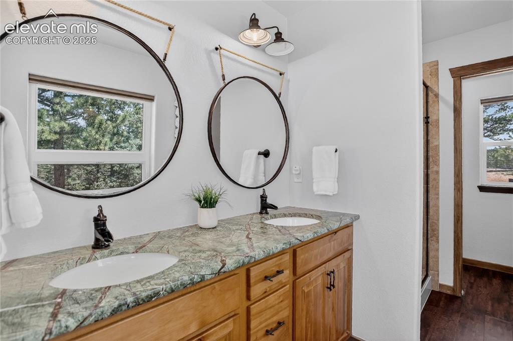 Image 14 of 28: Primary bath w/ dual sink vanity