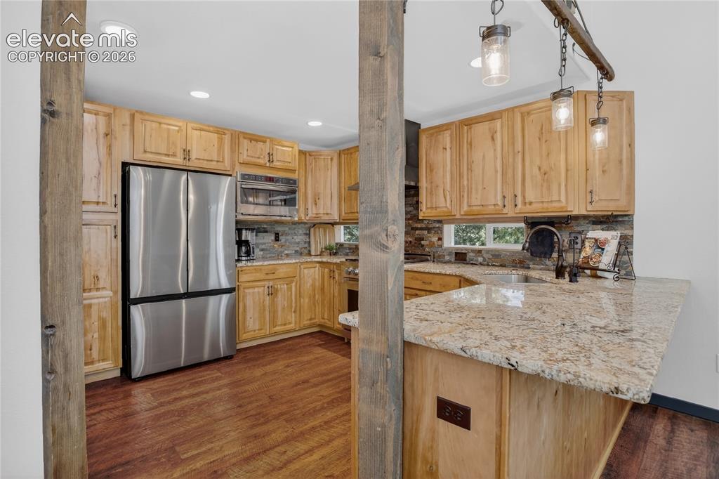 Image 7 of 28: Stone counters & bar stool seating