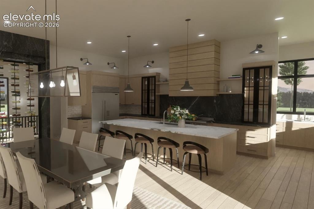 Image 16 of 24: Open concept living space featuring a built-in wine rack wall, large kitche