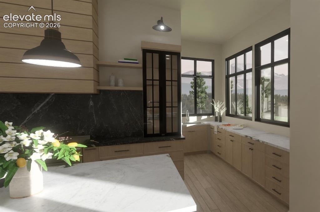 Image 18 of 24: Secondary prep kitchen with wood-finish plank flooring, light-toned cabinet