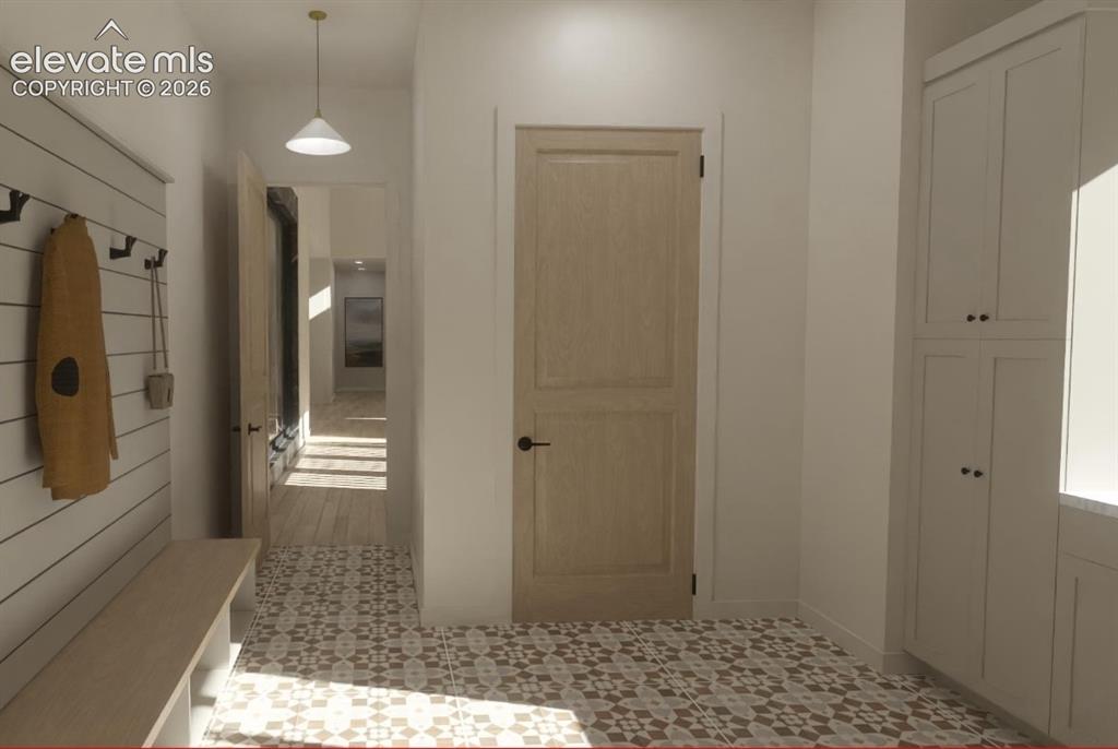 Image 24 of 24: Patterned tile flooring, built-in storage bench, white shiplap wall, light 