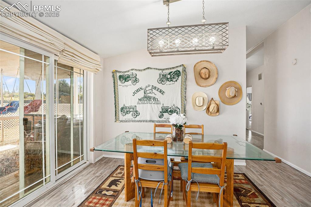 Image 7 of 24: Dining area with light wood-style flooring and baseboards