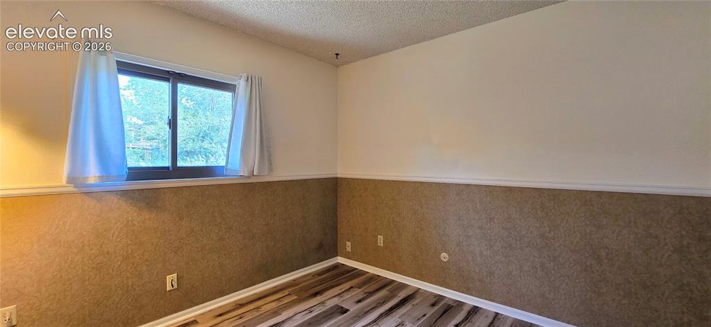 Image 17 of 17: Garage with storage shelves, and laundry nook (insulated)
