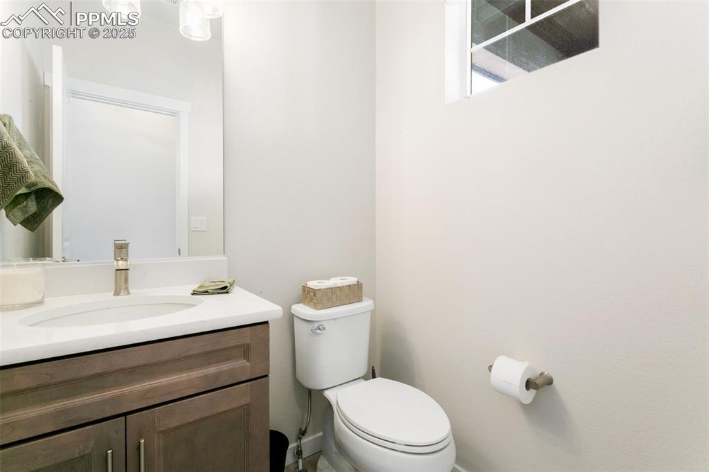 Image 14 of 50: Half bath featuring toilet and vanity