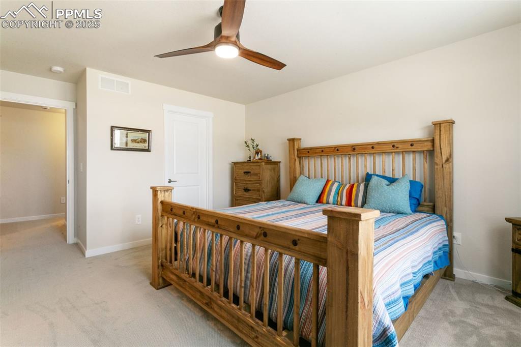 Image 24 of 50: Carpeted bedroom featuring baseboards and a ceiling fan