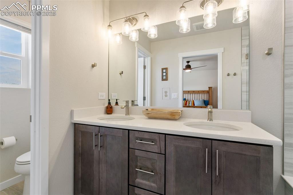 Image 26 of 50: Bathroom featuring double vanity and ceiling fan