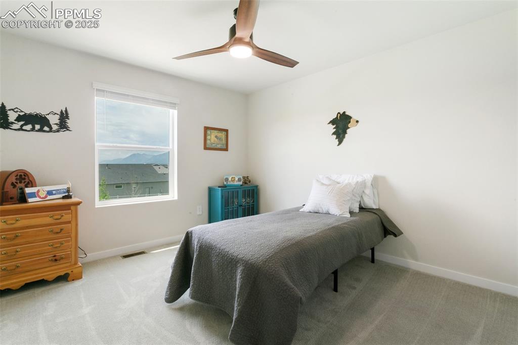 Image 28 of 50: Carpeted bedroom featuring baseboards and ceiling fan
