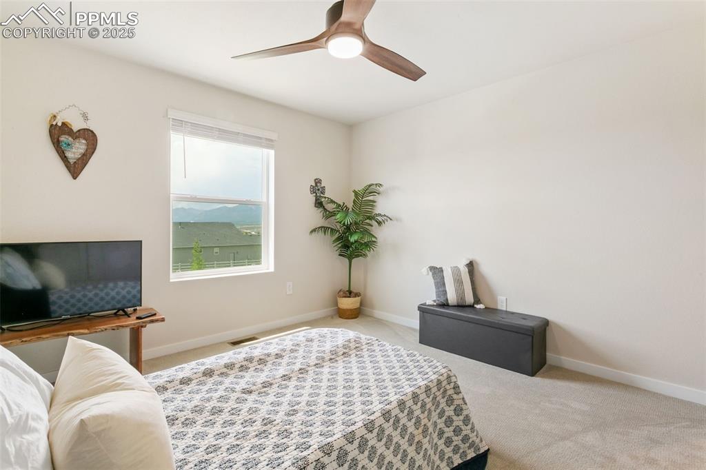 Image 33 of 50: Carpeted bedroom featuring baseboards and ceiling fan