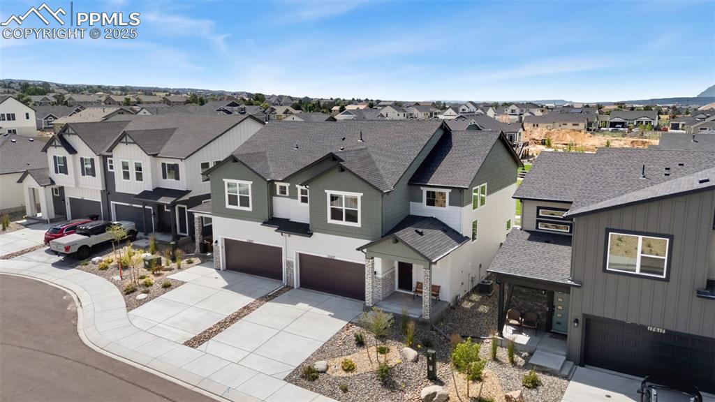 Image 38 of 50: View of front facade featuring a shingled roof, a residential view, concret