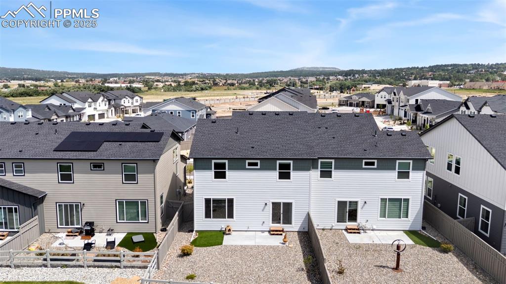Image 43 of 50: Back of property with a residential view, a patio, and a fenced backyard