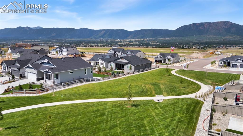 Image 46 of 50: Aerial view of residential area with a mountain backdrop