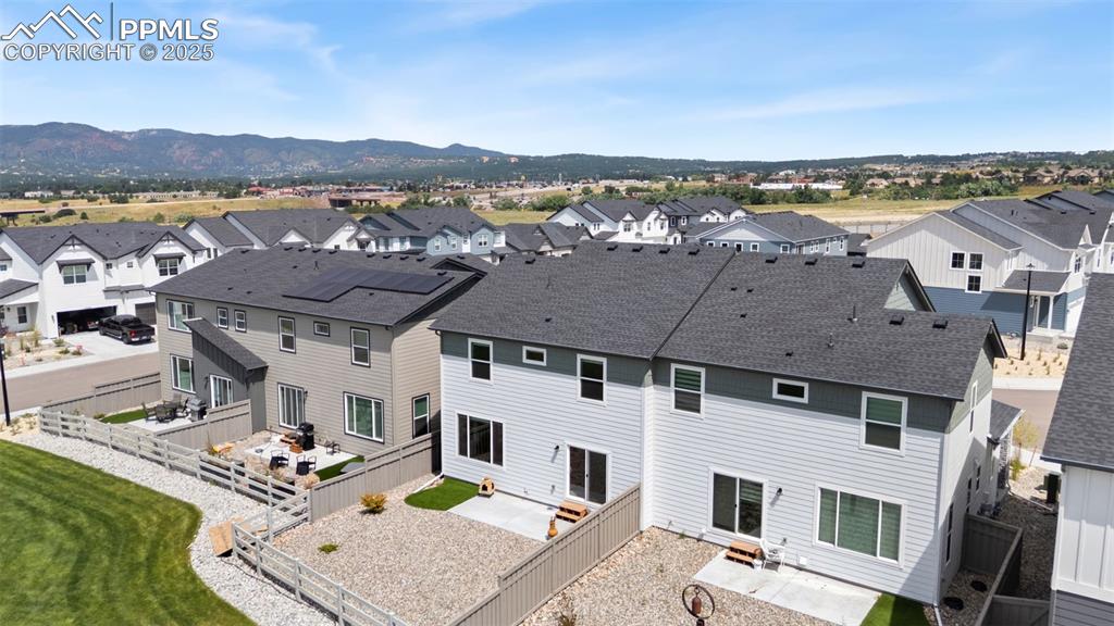 Image 47 of 50: Back of house featuring a residential view, a patio area, a fenced backyard