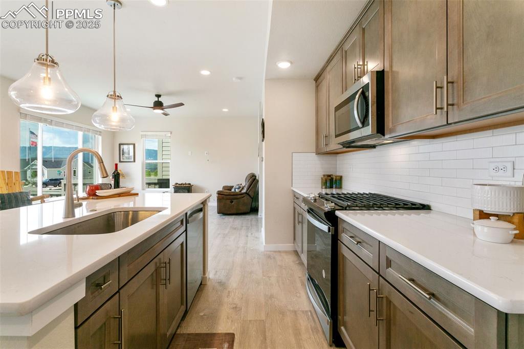 Image 5 of 50: Kitchen featuring appliances with stainless steel finishes, light wood-type