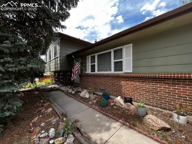 Caption: View of property exterior featuring brick siding