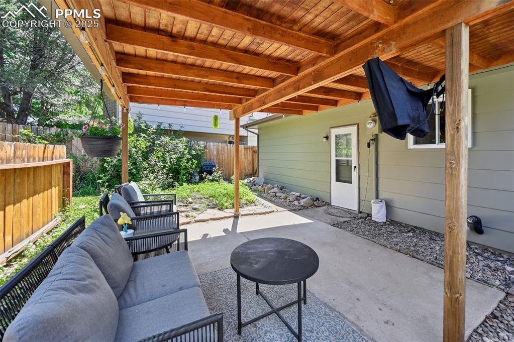 Image 24 of 31: Covered patio area and an outdoor hangout area