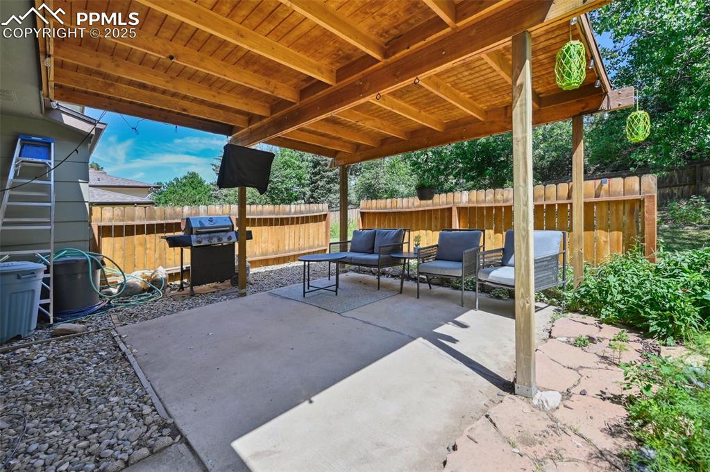 Image 25 of 31: Fenced backyard featuring grilling area, a patio, and an outdoor living spa