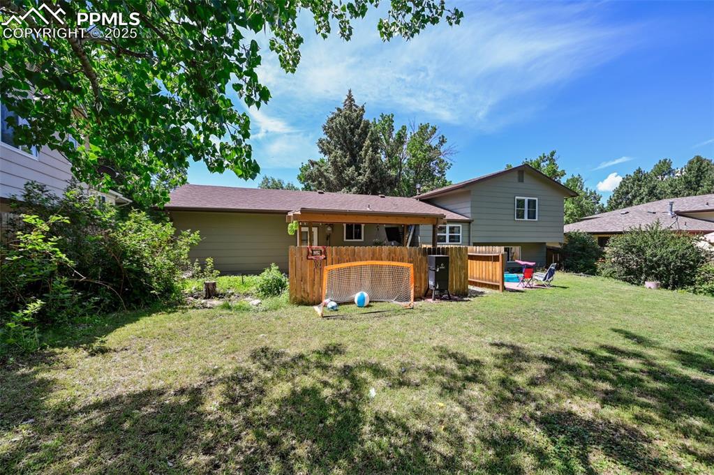 Image 26 of 31: Rear view of house with a lawn