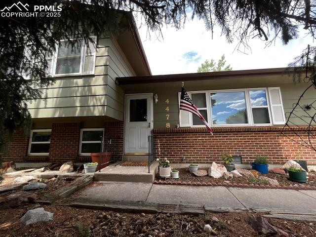 Image 3 of 31: View of front facade with brick siding