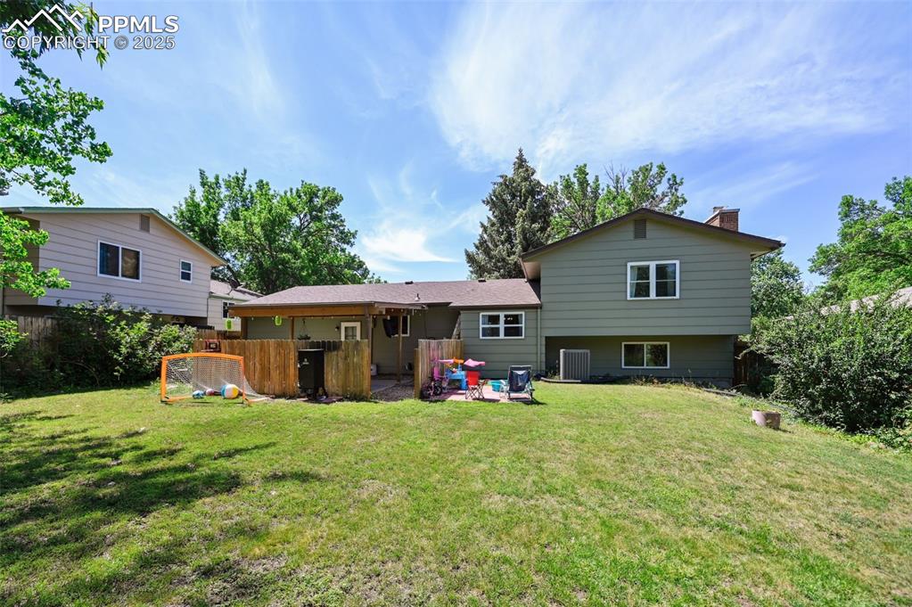Image 31 of 31: Rear view of property featuring a chimney
