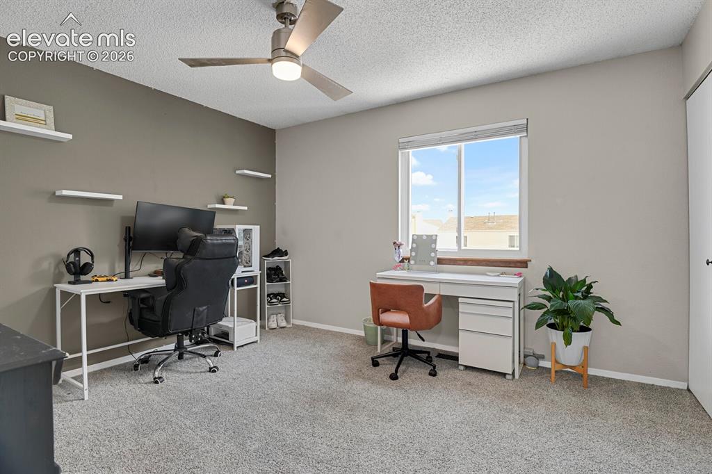 Image 19 of 32: Wall-to-wall carpeting with a neutral finish, a ceiling fan with integrated