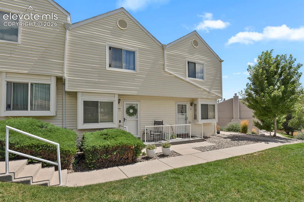 Image 2 of 32: Two-story townhouse with light-colored siding