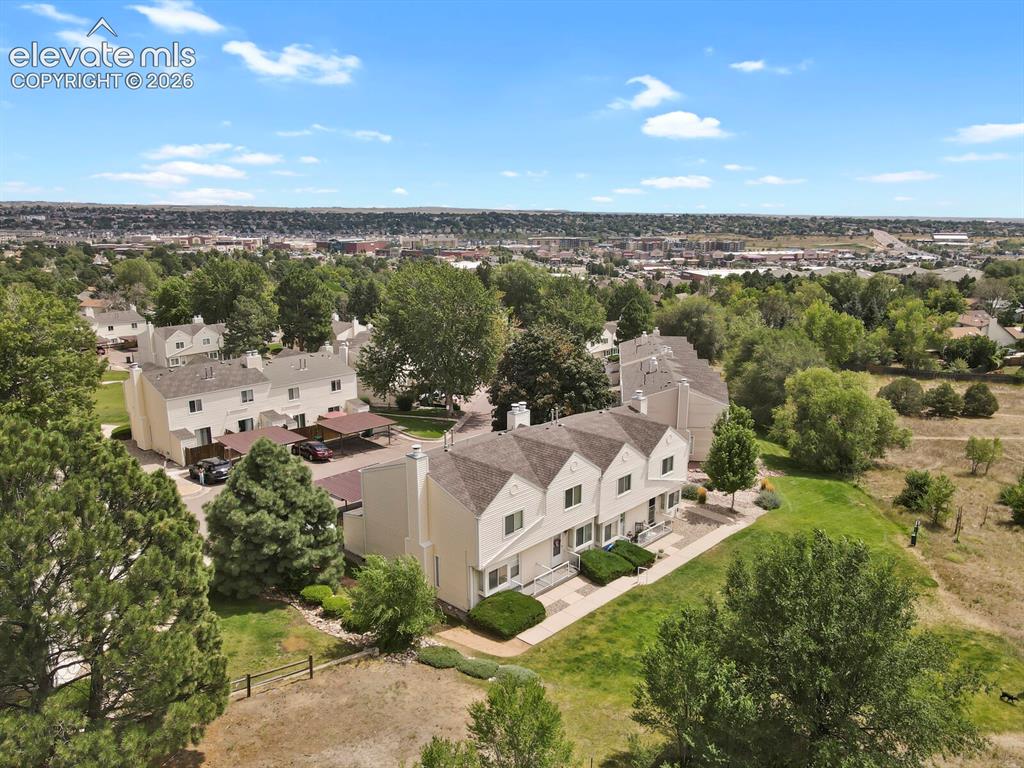 Image 28 of 32: Townhome community featuring neutral-toned exteriors, pitched roofs, and mu