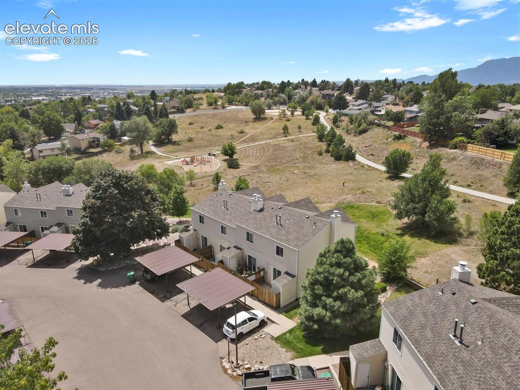 Image 30 of 32: Townhome property featuring carports, an outdoor patio, and a landscaped ya