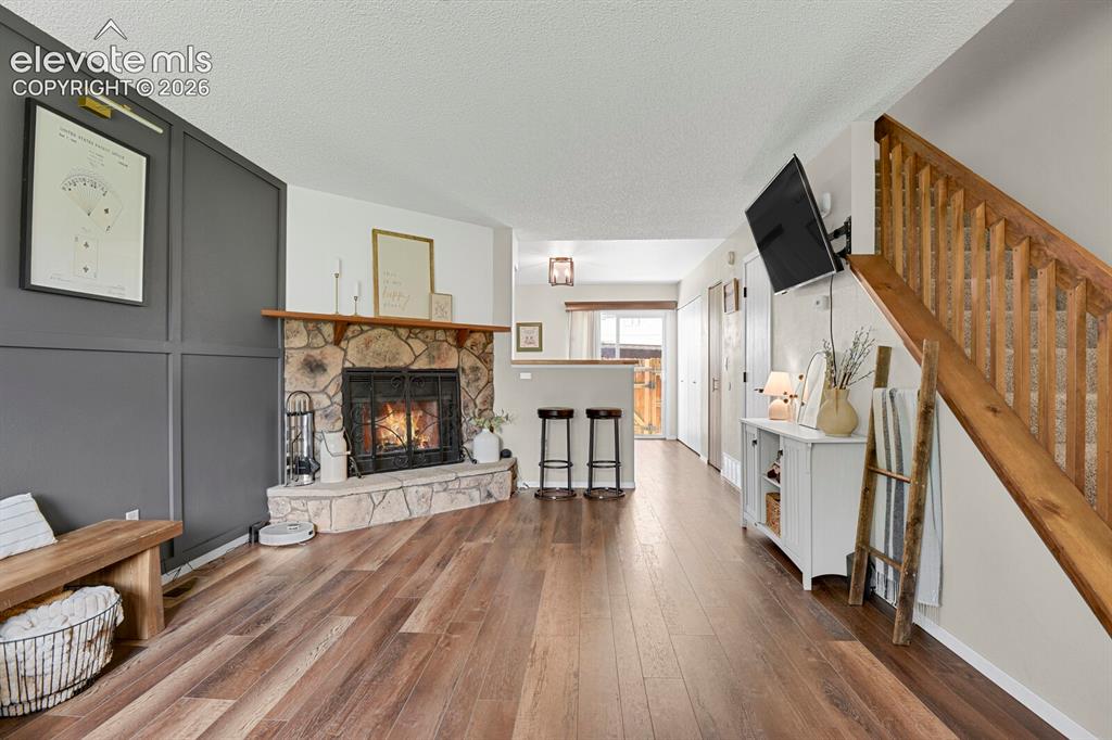 Image 6 of 32: Stone fireplace with a wood mantel