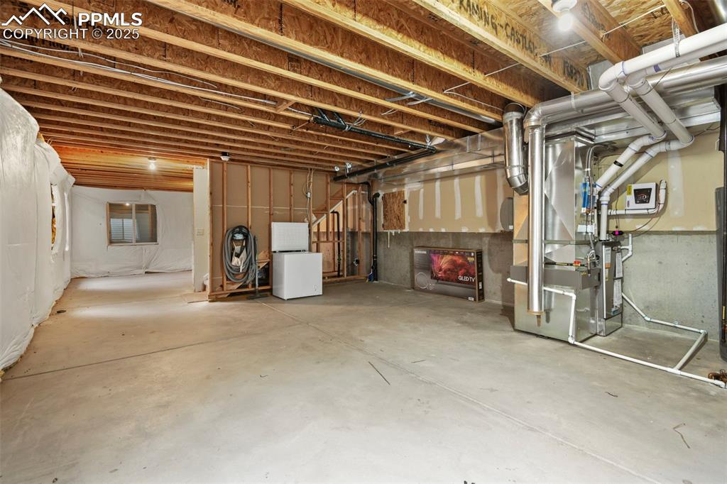 Image 24 of 32: Unfinished below grade area featuring heating unit