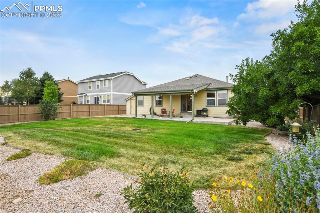 Image 3 of 32: Rear view of property with a patio area, a fenced backyard, and a shingled 