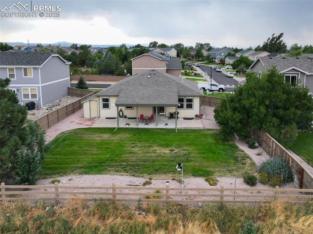 Image 32 of 32: Rear view of house featuring a patio area, a residential view, a fenced bac