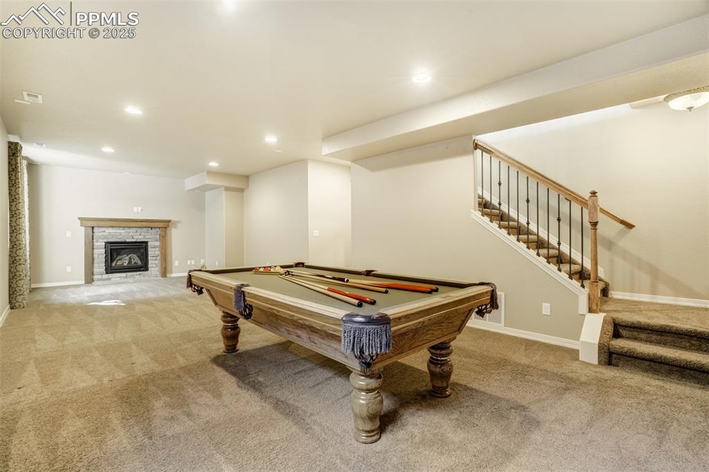 Image 21 of 36: Game room featuring carpet floors, recessed lighting, a fireplace, and bill