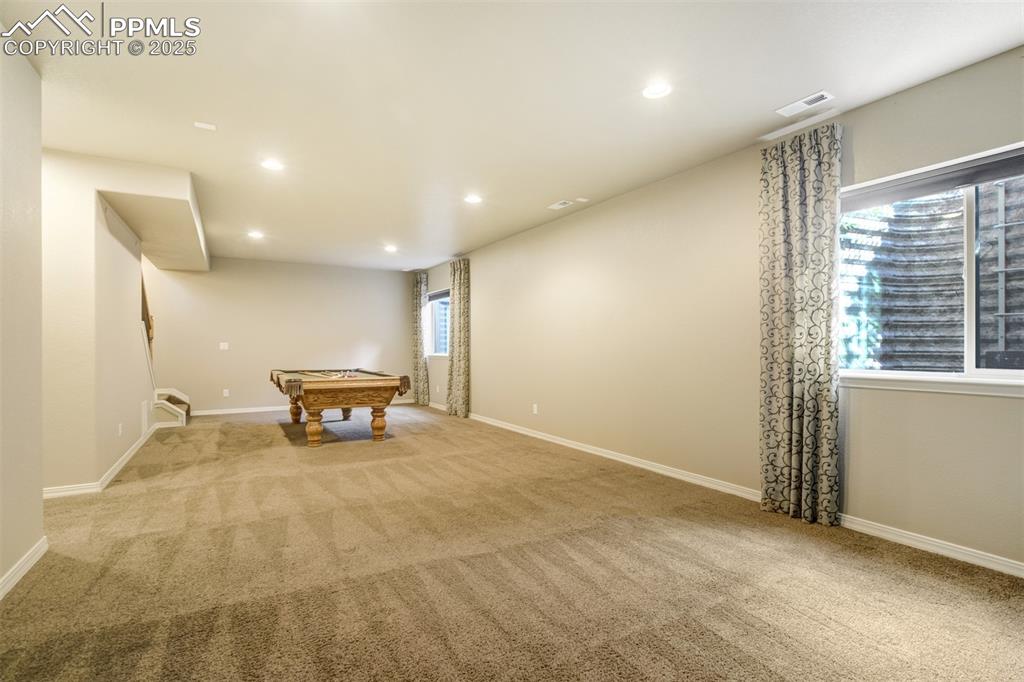 Image 22 of 36: Recreation room featuring light colored carpet, pool table, and recessed li